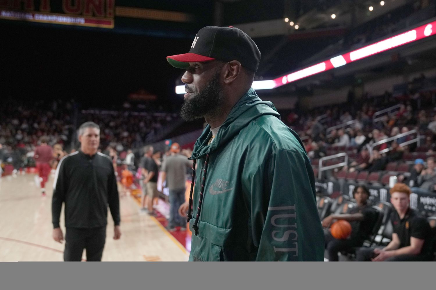 LeBron James watches the game between the USC Trojans and the Washington State Cougars.